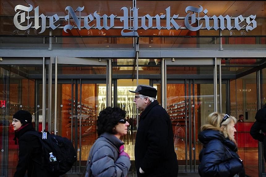 People walk by the entrance to US newspaper The New York Times in New York in this March 8, 2011 file photo.&nbsp;US daily newspapers slashed some 1,300 jobs in 2013, extending the steady declines over the past decade, a survey showed Tuesday. -- PHO