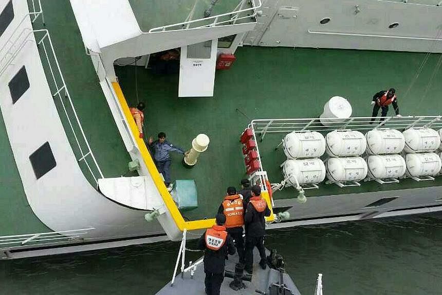 South Korea Coast Guard members rescuing some of the passengers and crew aboard a South Korean ferry sinking on its way to Jeju island from Incheon on April 16, 2014.&nbsp;Student survivors of South Korea's ferry disaster testified on Tuesday, July 2