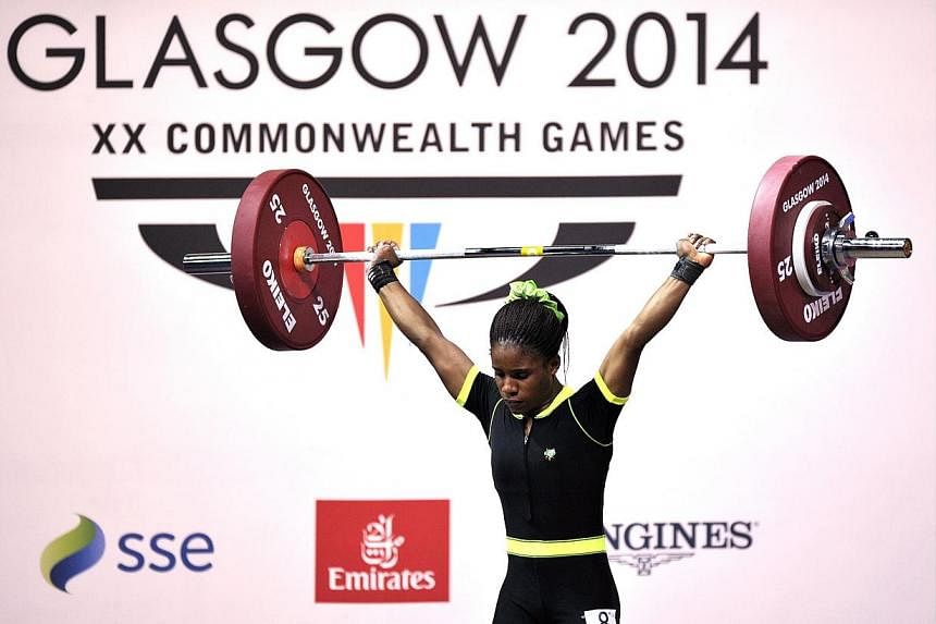 Nigeria's gold medalist Chika Amalaha competing in the women's weightlifting 53kg class, at the SECC Precinct during the 2014 Commonwealth Games in Glasgow, Scotland on July 25, 2014.&nbsp;-- PHOTO: AFP