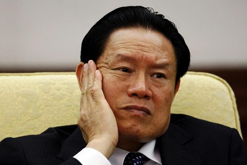 China's then Public Security Minister Zhou Yongkang reacts as he attends the Hebei delegation discussion sessions at the 17th National Congress of the Communist Party of China at the Great Hall of the People in Beijing on Oct 16, 2007.&nbsp;China's f