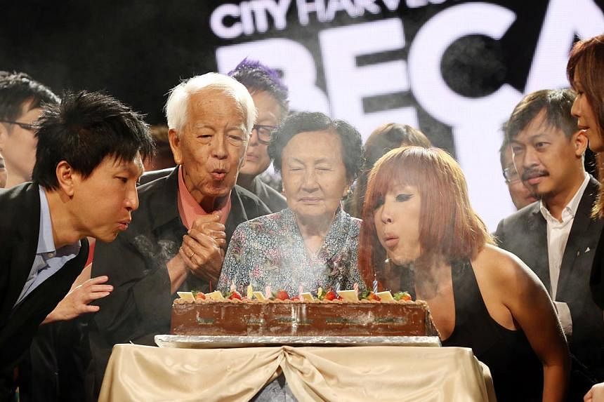 City Harvest Church Founder Kong Hee (left), his parents and wife Ho Yeow Sun blowing out candles to celebrate the church's 25th anniversary during Sunday morning service at Suntec City Convention Hall. -- ST PHOTO: SEAH KWANG PENG
