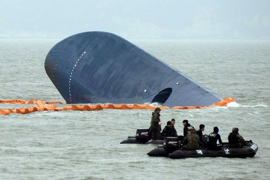 The driver of the South Korean businessman wanted over the sinking of a ferry that killed more than 300 people in April turned himself in on Tuesday, potentially unlocking the mystery of the man's final days after the disaster. -- PHOTO: AFP