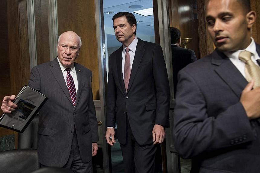 Committee chairman Senator Patrick Leahy (left),D-VT, and Federal Bureau of Investigation Director James Comey (centre) arrive for a hearing of the Senate Judiciary Committee on Capitol Hill on May 21, 2014 in Washington, DC.&nbsp;A new Senate propos