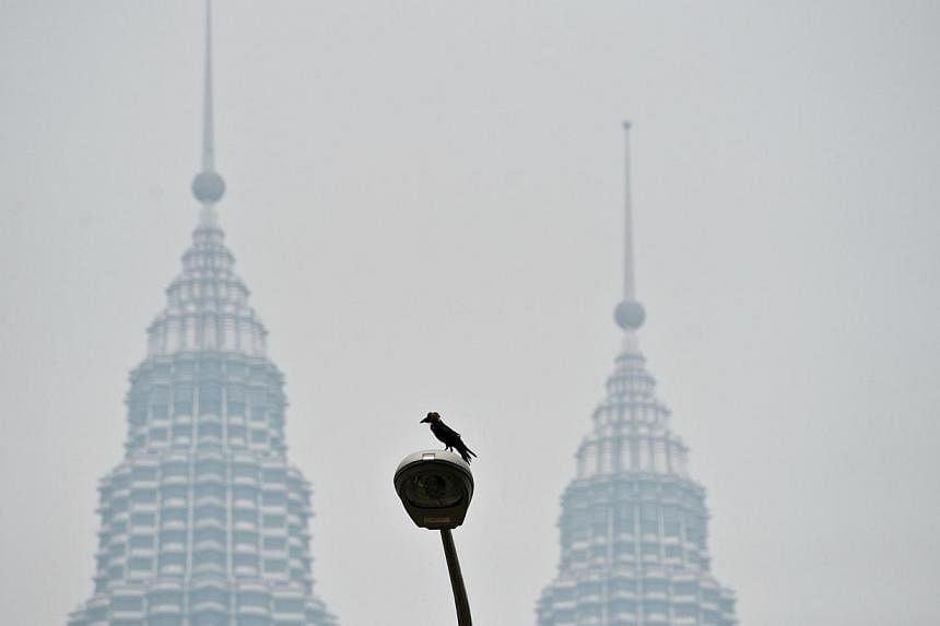 Malaysia's iconic Twin Towers emerge out of thick haze in Kuala Lumpur on July 29, 2014. Air quality around Malaysia's capital and on Borneo island was "unhealthy", with one town reaching "very unhealthy" levels as haze, mostly from forest fires in I