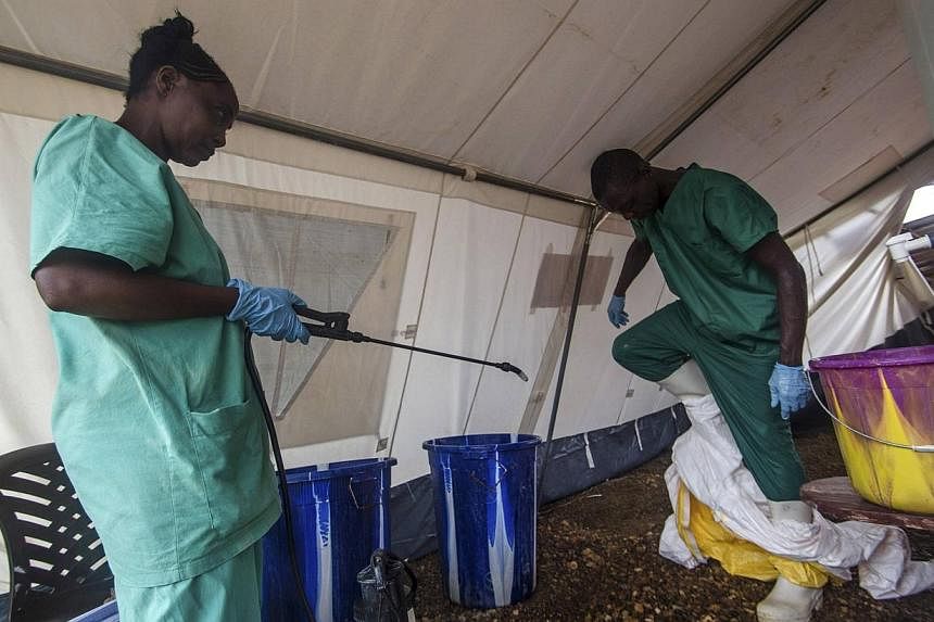 A health worker removes his protective suit as he emerges from an isolation area at the Medecins sans Frontieres Ebola treatment centre in Kailahun on July 20, 2014.&nbsp;Fears that the west African Ebola outbreak could spread to other continents gre