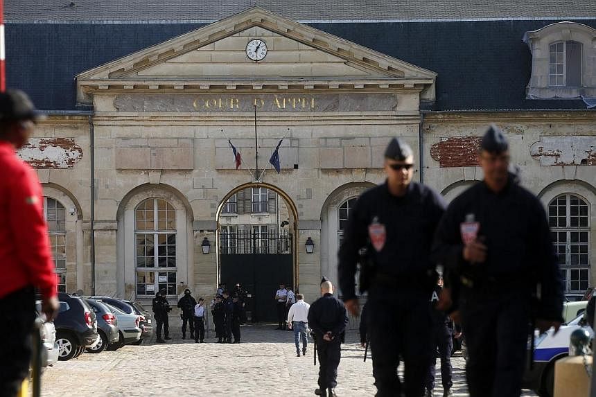 Police officers secure the entrance of the Appeal Court of Versailles for the arrival of vehicles transporting Mehdi Nemmouche, 29, the French national who is suspected of the shooting attack in the Brussels Jewish Museum last month that left four pe