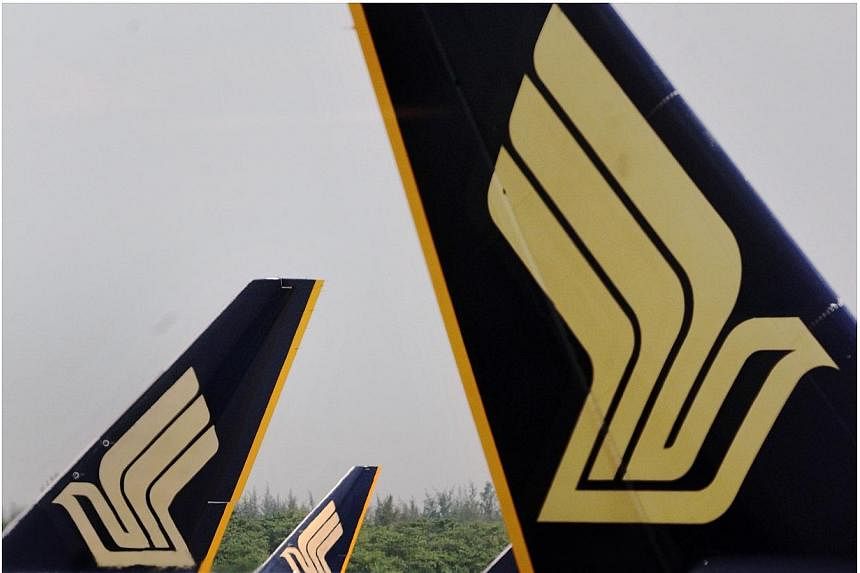 Singapore Airlines said on Wednesday, July 30, 2014, its financial first quarter net profit plunged 71.4 per cent from the previous year, weighed down by lower passenger and cargo revenue. -- PHOTO: ST FILE