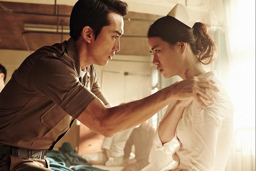 Song Seung Heon plays a decorated war hero who falls in love with his subordinate's wife (Lim Ji Yeon, both above) in Obsessed.