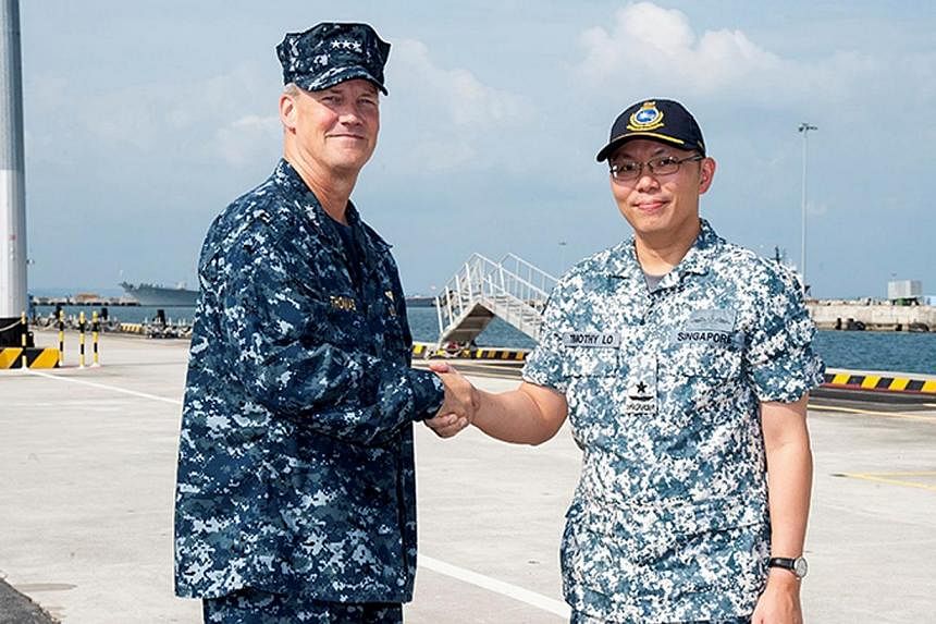 US 7th Fleet Vice-Admiral Robert L. Thomas (left) and Rear-Admiral Timothy Lo shaking hands at the Exercise Carat's opening ceremony.