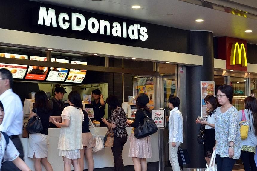 Customers order food at a McDonald's restaurant in Tokyo on July 25, 2014. -- PHOTO: AFP