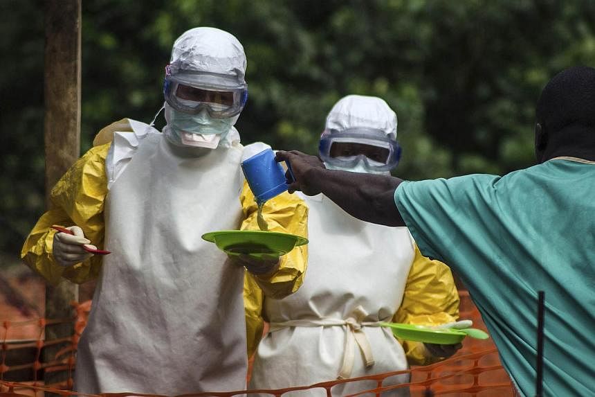 Medical staff working with Medecins sans Frontieres (MSF) prepare to bring food to patients kept in an isolation area at the MSF Ebola treatment centre in Kailahun on July 20, 2014.&nbsp;Fears that the west African Ebola outbreak could spread to Euro