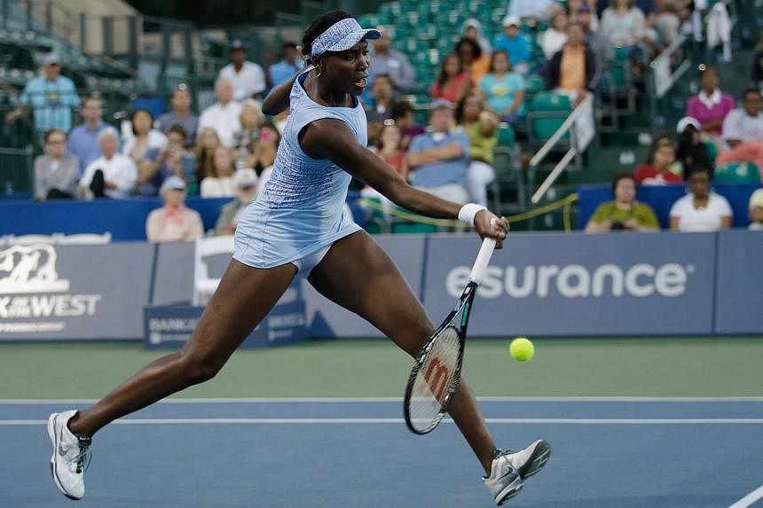 Venus Williams returns a shot to Paula Kania of Poland during Day 2 of the Bank of the West Classic at the Taube Family Tennis Stadium on July 29, 2014, in Stanford, California. Williams advanced to the second round of the WTA Stanford hardcourt tour