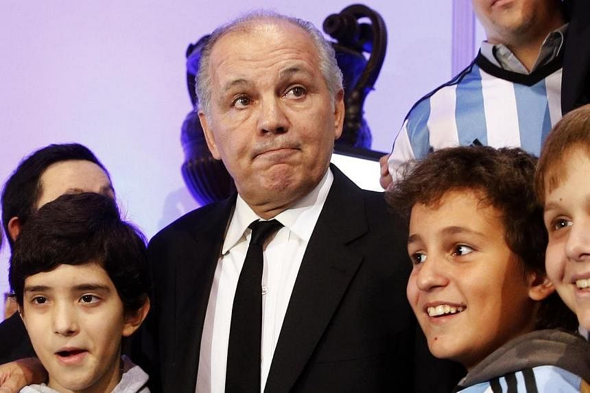 Argentina's national soccer team coach Alejandro Sabella poses for a picture with children during a ceremony in his honour at the Argentine Congress in Buenos Aires on July 22, 2014.&nbsp;Sabella will not renew his contract once it expires in Septemb
