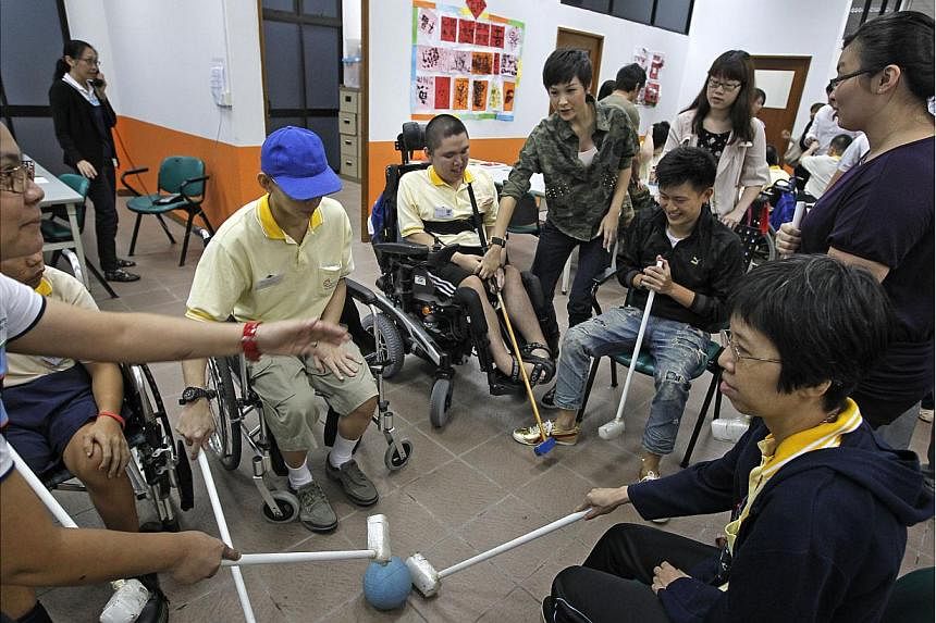 Beneficiaries of the Society for the Physically Disabled playing a modified hockey game in 2013. -- PHOTO: ST FILE