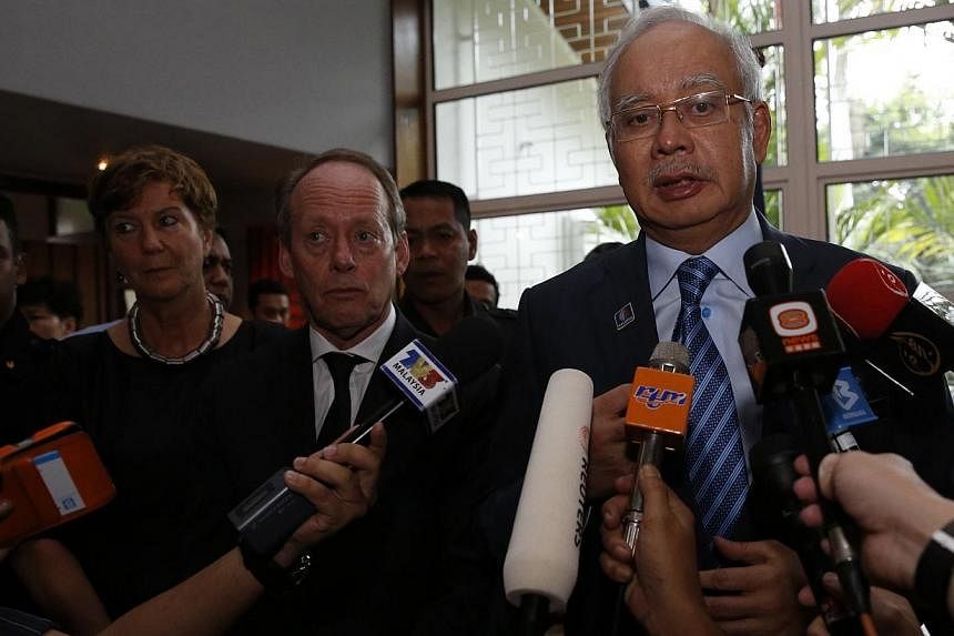 Malaysian Prime Minister Najib Razak (right), with Dutch ambassador Harry Molenaar, speaks to the press about the recovery of bodies killed when Malaysian Airlines MH17 was shot down over the Ukraine, at the residence of the Netherlands' ambassador i