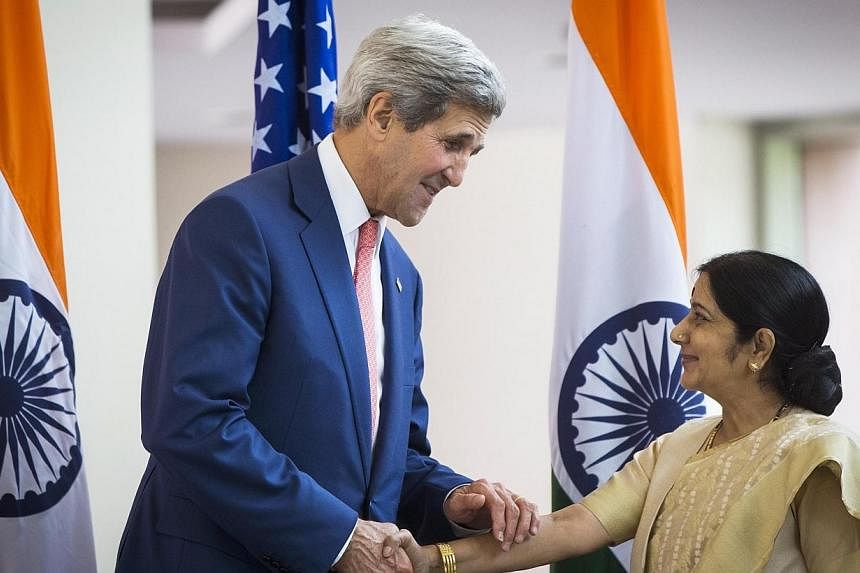 US Secretary of State John Kerry (left) greets Indian External Affairs Minister Sushma Swaraj in New Delhi on July 31, 2014. -- PHOTO: REUTERS