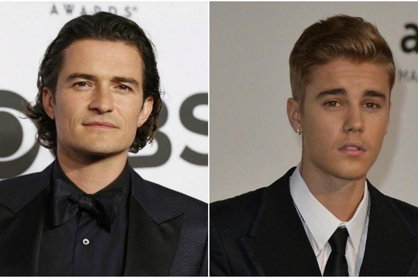British actor Orlando Bloom has reportedly tried to punch pop singer Justin Bieber. -- PHOTO: REUTERS/AFP