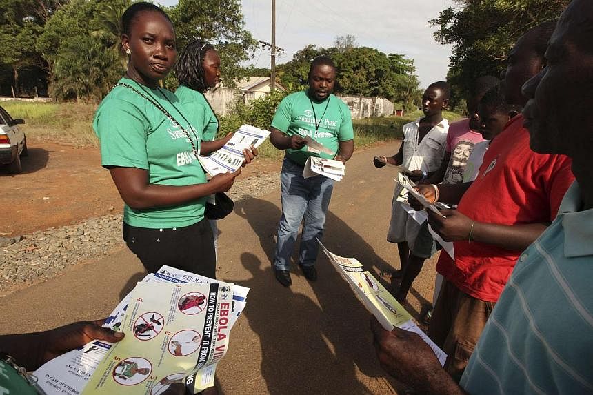 A Samaritan's Purse team member hands out pamphlets to educate the public on the Ebola virus in Monrovia, Liberia in this undated handout photo courtesy of Samaritan's Purse. -- PHOTO: REUTERS