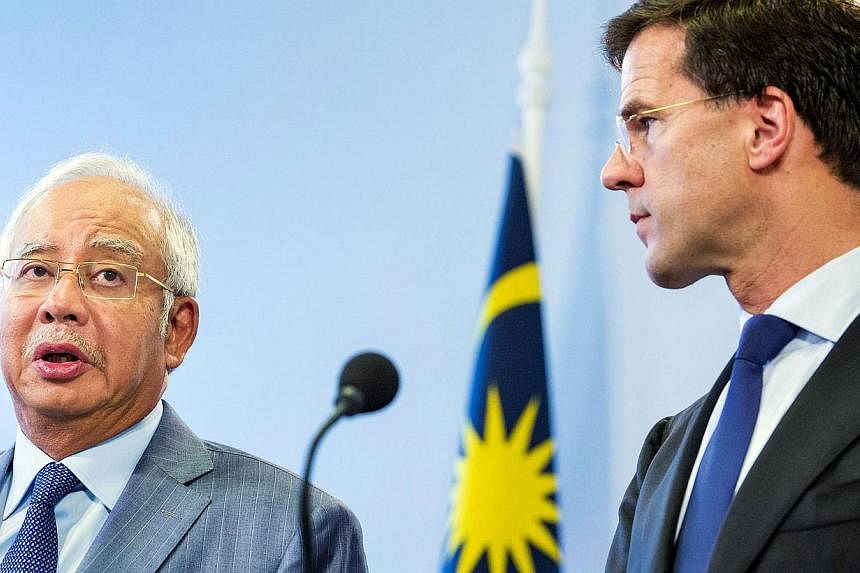 Dutch Prime Minister Mark Rutte (right ) looks on as his Malaysian counterpart Najib Razak speaks during a press conference at the Parliament building in The Hague, the Netherlands, on July 31, 2014. -- PHOTO: AFP&nbsp;