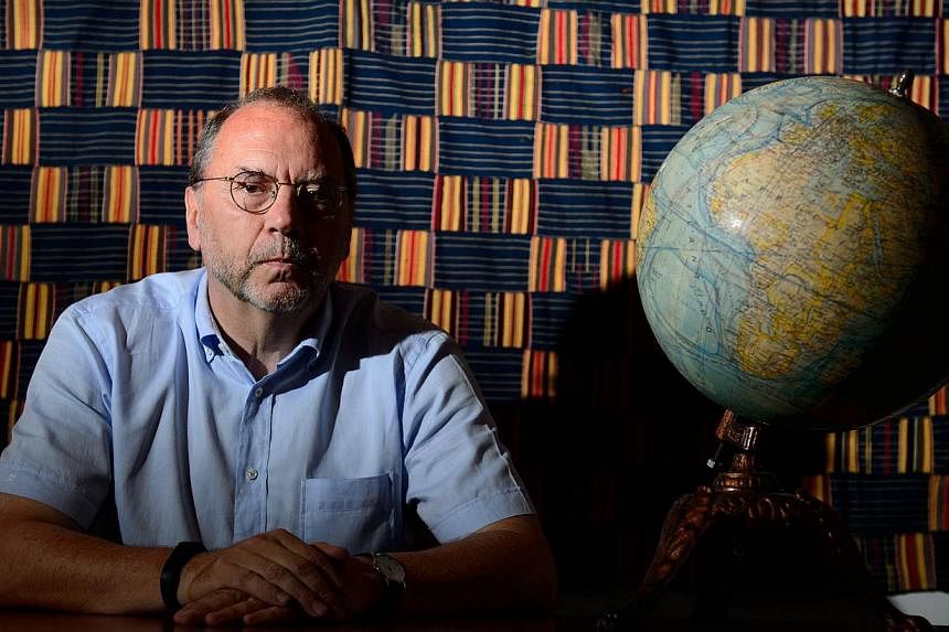 Professor Peter Piot, the Director of the London School of Hygiene and Tropical Medicine, poses for photographs following an interview at his office in central London, England, on July 30, 2014. -- PHOTO: AFP