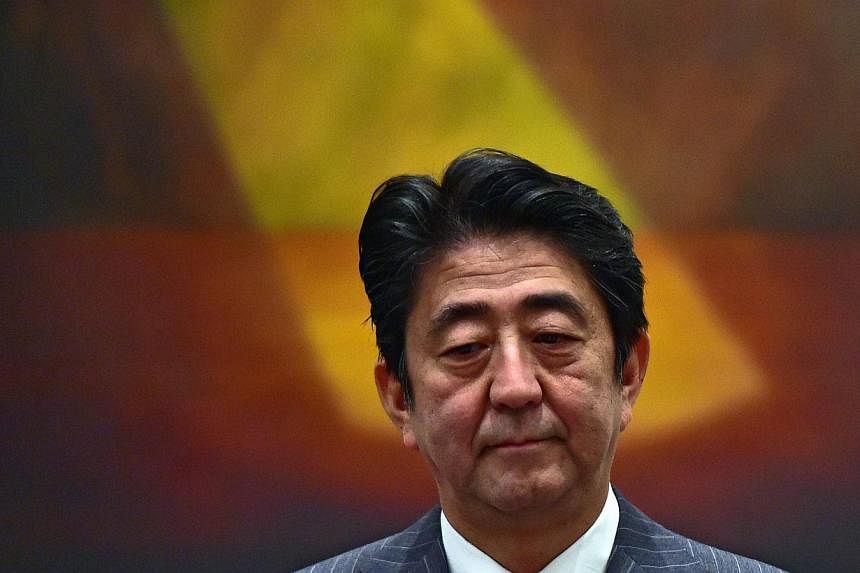 Japan's PM Shinzo Abe speaks during a meeting with members of the Japanese community in Santiago on July 30, 2014. Mr Abe said he plans to revamp his cabinet in early September for the first time since taking office, on the back of falling approval r