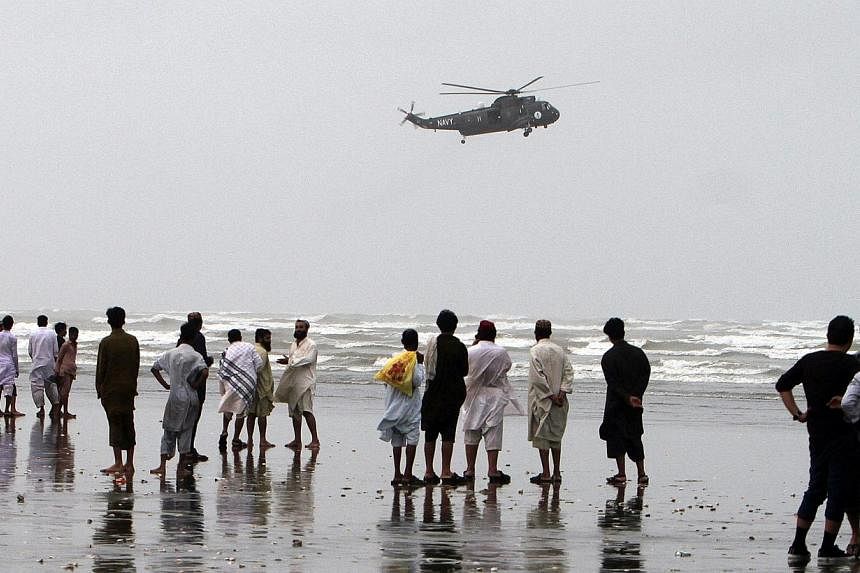 A Pakistan Navy Sea King helicopter arrives for a search and recovery mission over Clifton beach in Karachi on July 31, 2014. -- PHOTO: AFP