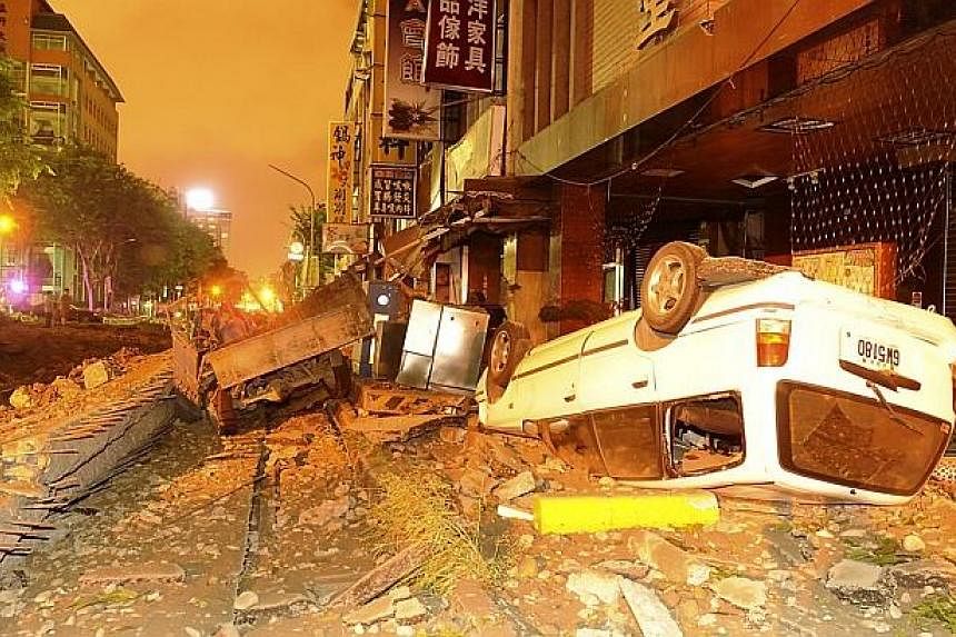 The wreckage of vehicles is seen among debris after an explosion in Kaohsiung, southern Taiwan on Aug 1, 2014. -- PHOTO: REUTERS