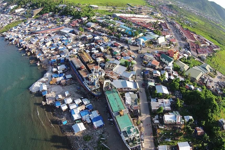 Aerial of the coastal community, with ships brought aground by Typhoon Haiyan, in Anibong subdistrict of Tacloban City, Leyte province, in central Philippines on May 1, 2014. -- ST PHOTO: KEVIN LIM