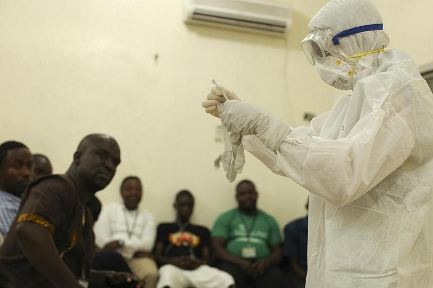 A Samaritan's Purse medical personnel demonstrates personal protective equipment to educate team members on the Ebola virus in Liberia in this undated handout photo courtesy of Samaritan's Purse. -- PHOTO: REUTERS