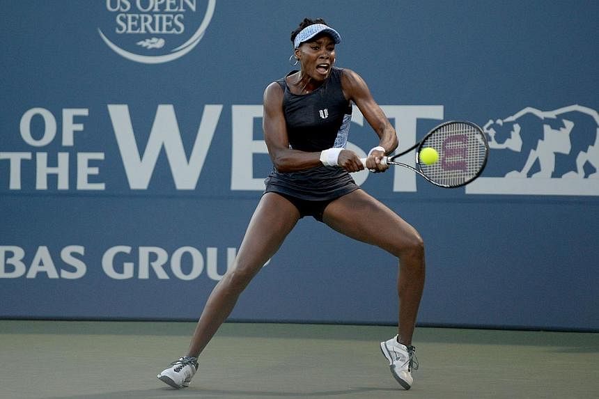 Venus Williams of the Unites States of America plays against Victoria Azarenka of Belarus during Day 4 of the Bank of the West Classic at the Taube Family Tennis Stadiumon on July 31, 2014, in Stanford, California. -- PHOTO: AFP