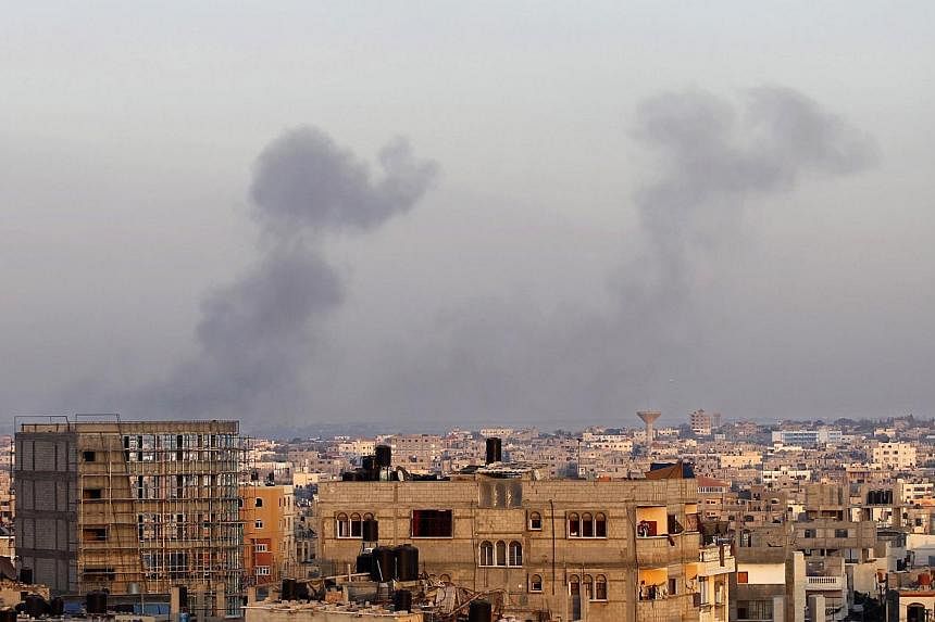 Smoke billows from buildings following an Israeli air strike in Rafah, in the southern Gaza Strip, on July 31, 2014.&nbsp;A 72-hour ceasefire between Israel and Gaza militants went into effect on Friday, as a diplomatic push for a more durable end to