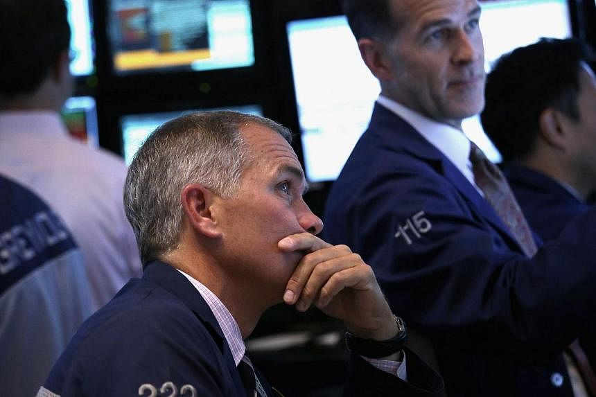 Traders work the floor of the New York Stock Exchange on July 31, 2014 in New York City. US stocks finished sharply lower after a news-packed week that bolstered confidence in the economy even as speculation grew that the Federal Reserve will more qu