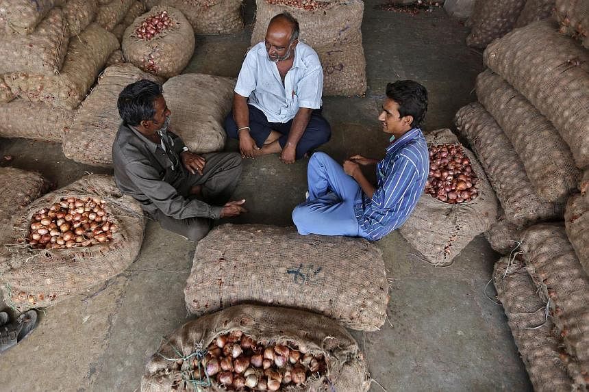 Traders sit amidst stacked sacks filled with onions and potatoes at a wholesale vegetable market in Ahmedabad. A World Trade Organisation pact to ease worldwide customs rules collapsed late on Thursday over India's demands for concessions on agricult