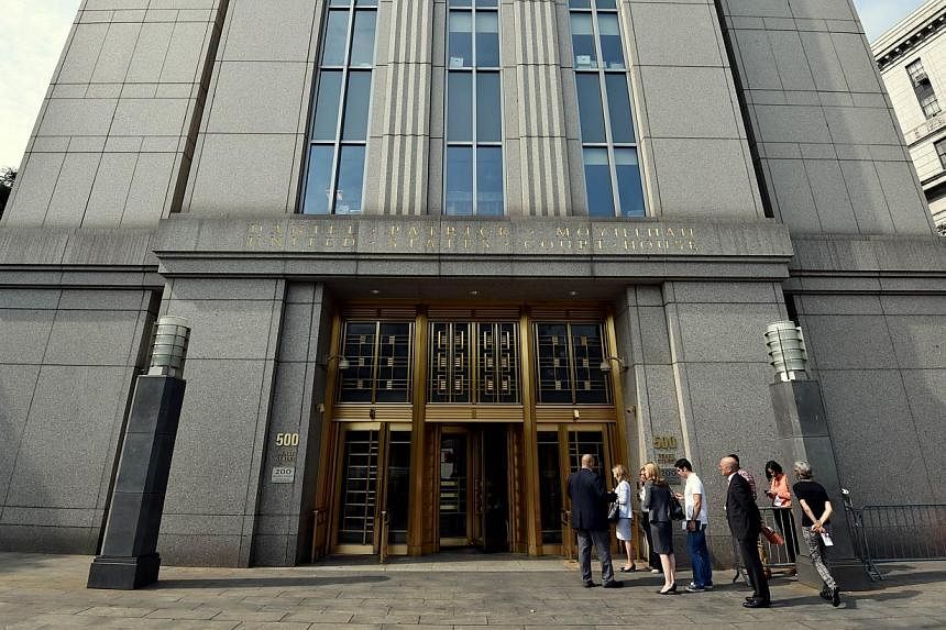 People line up to enter the US Federal Courthouse on Aug 1, 2014 in New York where they will continue with litigation into the Argentinian debt. -- PHOTO: AFP&nbsp;
