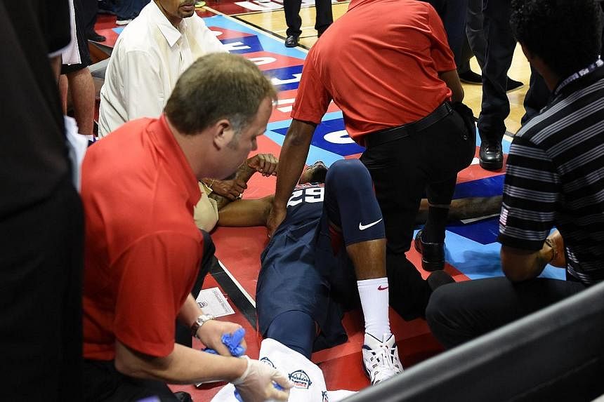 Paul George #29 of the 2014 USA Basketball Men's National Team is tended to as he lies on the court after badly injuring his leg defending a play during a USA Basketball showcase at the Thomas &amp; Mack Center on Aug 1, 2014 in Las Vegas, Nevada. --