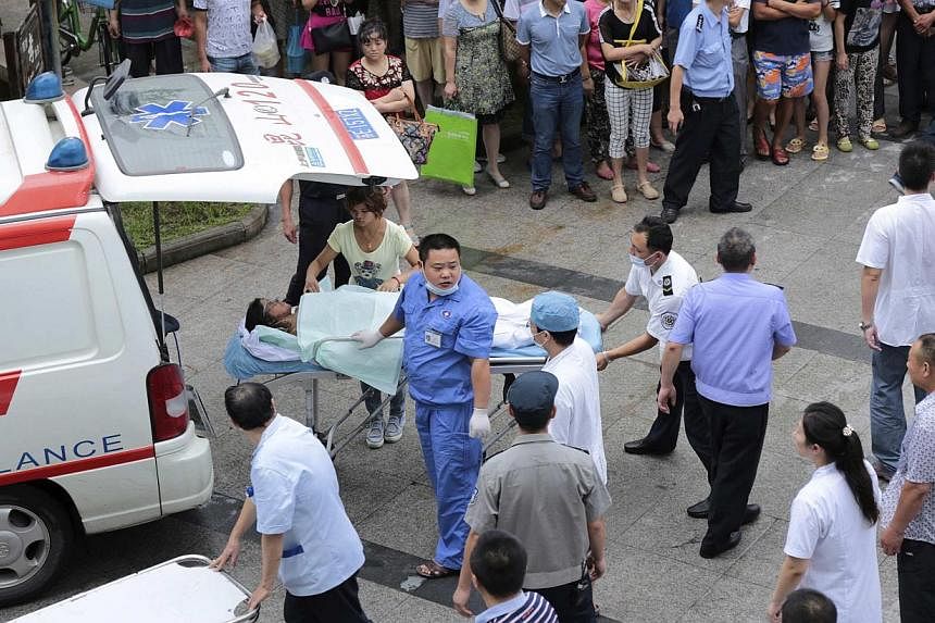 Medical personnel transport a victim (centre) at a hospital after an explosion at a factory in Kunshan, Jiangsu province, on Aug 2, 2014. The blast killed 65 people, a government broadcaster said, and injured 150 in what appeared to be an industrial 