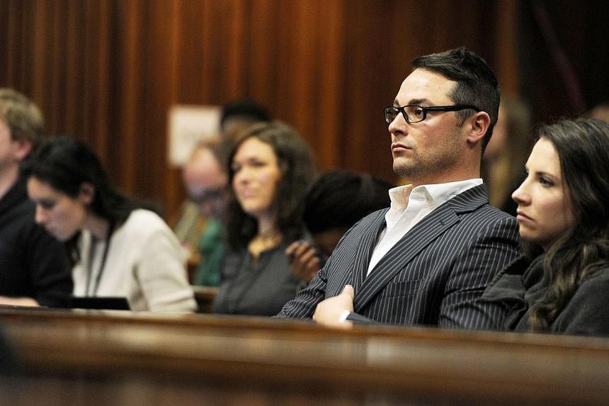 Carl Pistorius (second, right) and Aimee Pistorius (right), the siblings of South African paralympian Oscar Pistorius, sit at the High Court in Pretoria during Oscar Pistorius' trial on July 2, 2014. -- PHOTO: AFP