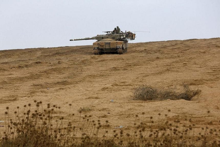 An Israeli tank is seen near the Israeli border with the Gaza Strip on Aug 2, 2014.&nbsp;The Israeli army on Saturday, Aug 2, 2014, informed residents of Beit Lahiya in northern Gaza that it was "safe" to return to their homes, as witnesses said troo