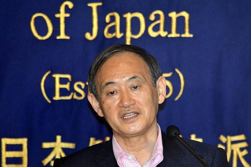 Japan's Chief Cabinet Secretary Yoshihide Suga speaks during a press conference at the Foreign Correspondents' Club of Japan in Tokyo on July 11, 2014. -- PHOTO: AFP