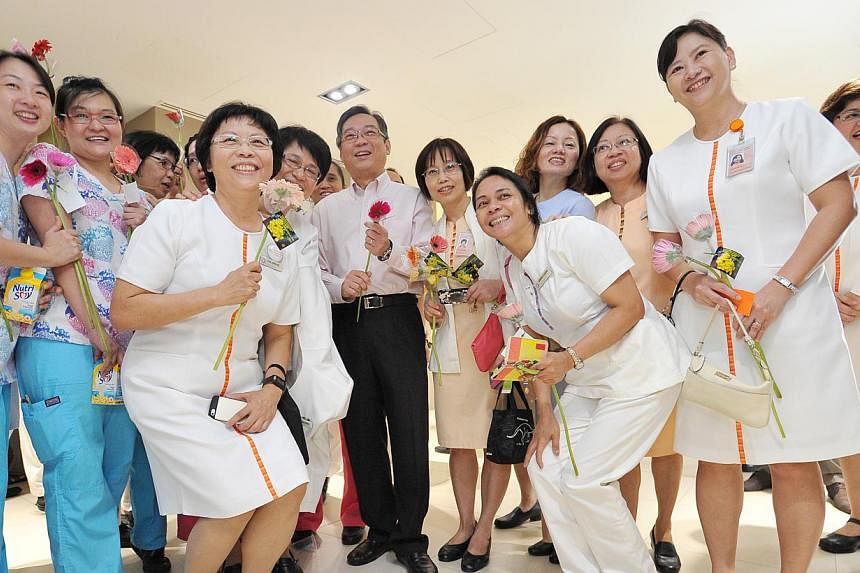 Health Minister Gan Kim Yong (centre) with nurses and staff at the SingHealth Nurses' Day celebration held at The Academia, SGH Campus, yesterday.