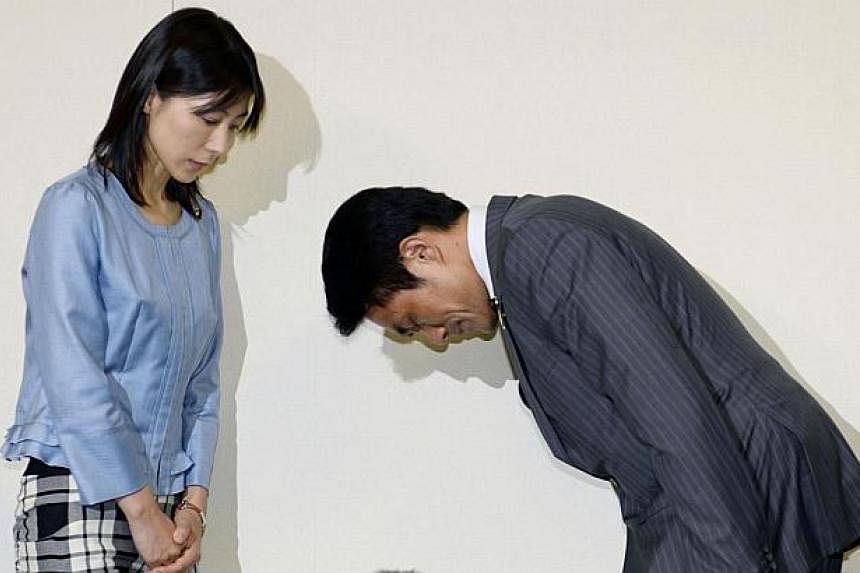 File picture of Tokyo city assembly lawmaker Akihiro Suzuki (R) bowing to apologise to female lawmaker Ayaka Shiomura last month for hurling sexist jibes at her in the Tokyo assembly when she was talking about measures to support child raising and bo