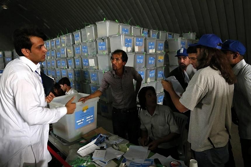 Afghan election workers count ballot papers during an audit of the presidential run-off in Kabul on Sunday, Aug 3, 2014.&nbsp;Afghanistan's troubled presidential election plunged deeper into crisis on Sunday when one of the main contenders accused a 