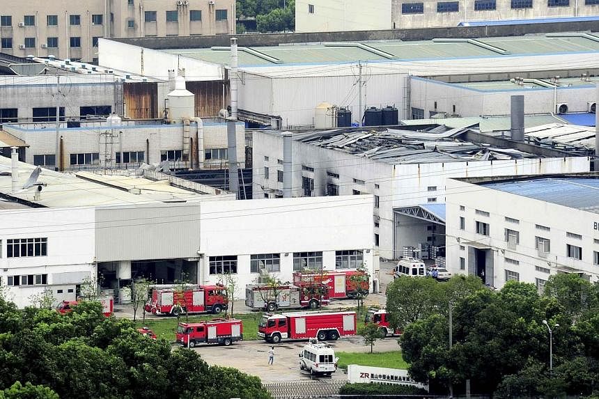 Firefighter trucks are seen next to a damaged building after an explosion at a factory in Zhoushan, Jiangsu province on Saturday, Aug 2, 2014.&nbsp;General Motors said on Sunday, Aug 3, that it had asked its main Chinese supplier to find an alternati