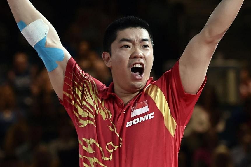 Singapore's Zhan Jian celebrates winning against England's Paul Drinkhall during their team table tennis gold medal match at the Scotstoun Sports Campus at the 2014 Commonwealth Games in Glasgow. -- PHOTO: AFP