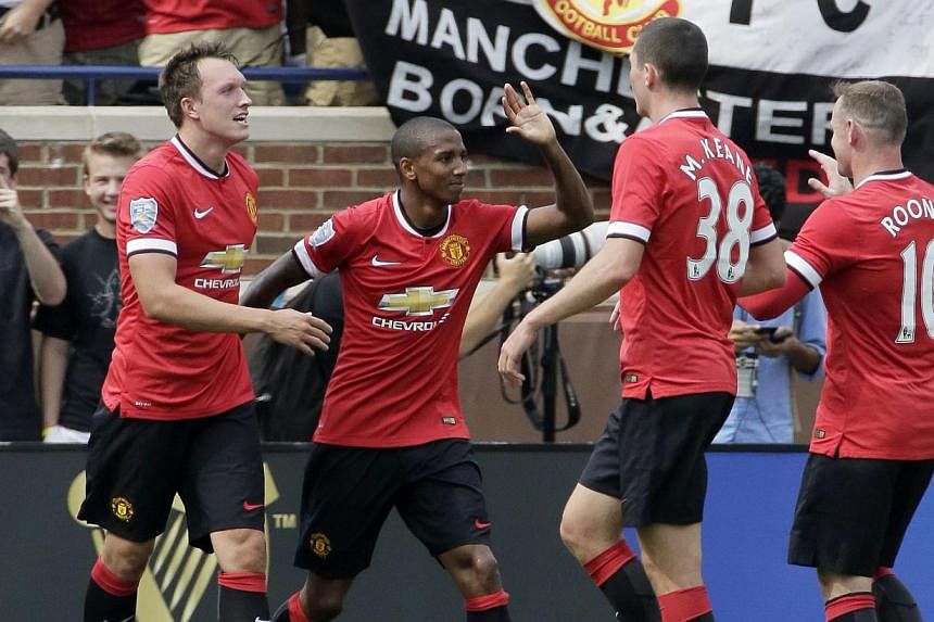 Ashley Young (#18) of Manchester United celebrates his first half goal against Real Madrid with Michael Keane (#38), Wayne Rooney (#10) and Phil Jones (#4), left, during the Guinness International Champions Cup at Michigan Stadium. -- PHOTO: AFP