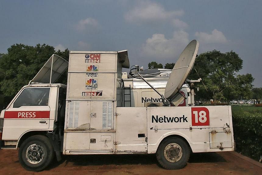 A van of media group Network18 is parked outside the Indian parliament in New Delhi on July 16, 2014.-- PHOTO: REUTERS