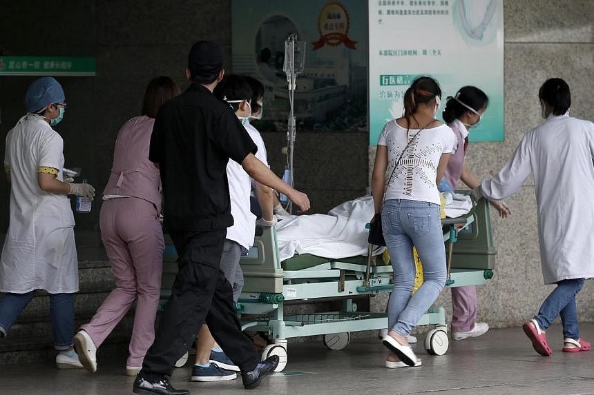Medical personnel transport a victim of a factory explosion at a hospital in Kunshan, Jiangsu province on Saturday, Aug 2, 2014.&nbsp;The death toll from an explosion at a Taiwan-invested car parts factory in China reached 69 by Sunday, state media s