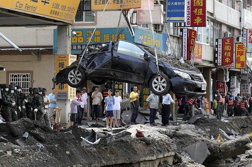 A damaged car is removed from the wreckage after an explosion in Kaohsiung, southern Taiwan, on Aug 2, 2014.&nbsp;The head of the company allegedly responsible for deadly explosions that rocked Taiwan's second city apologised on Sunday, Aug 3, as the