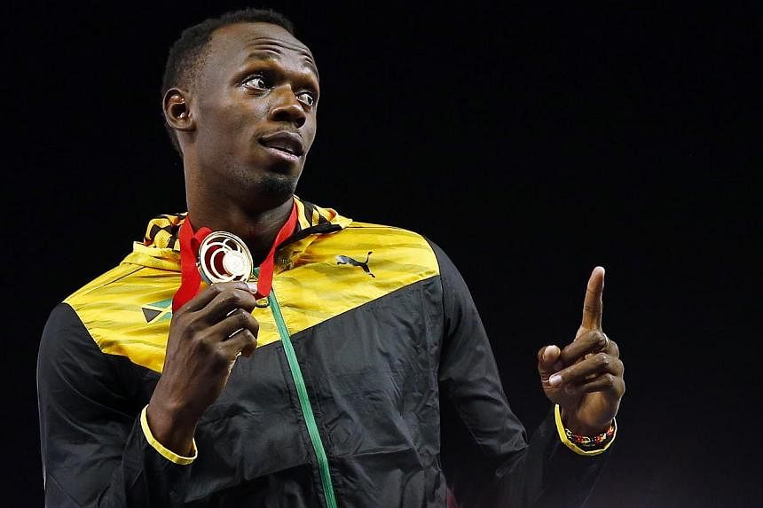 Jamaica's Usain Bolt holds his gold medal after Jamaica won the men's 4x100m relay final at the 2014 Commonwealth Games in Glasgow, Scotland, on Aug 2, 2014. -- PHOTO: REUTERS