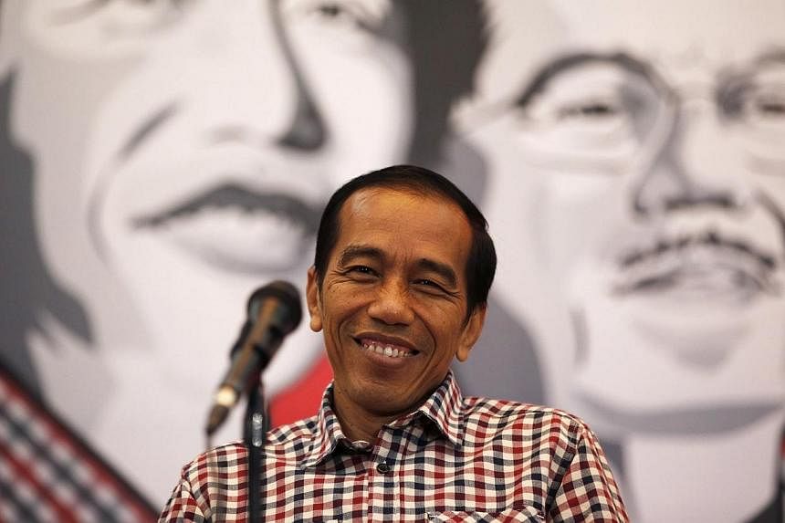 Presidential candidate Joko Widodo smiles during a news conference in Bandung July 3, 2014.&nbsp;Indonesia's president-elect Joko Widodo on Monday, Aug 4, 2014, announced a high-powered advisory team to handle his transition to power as he prepares t